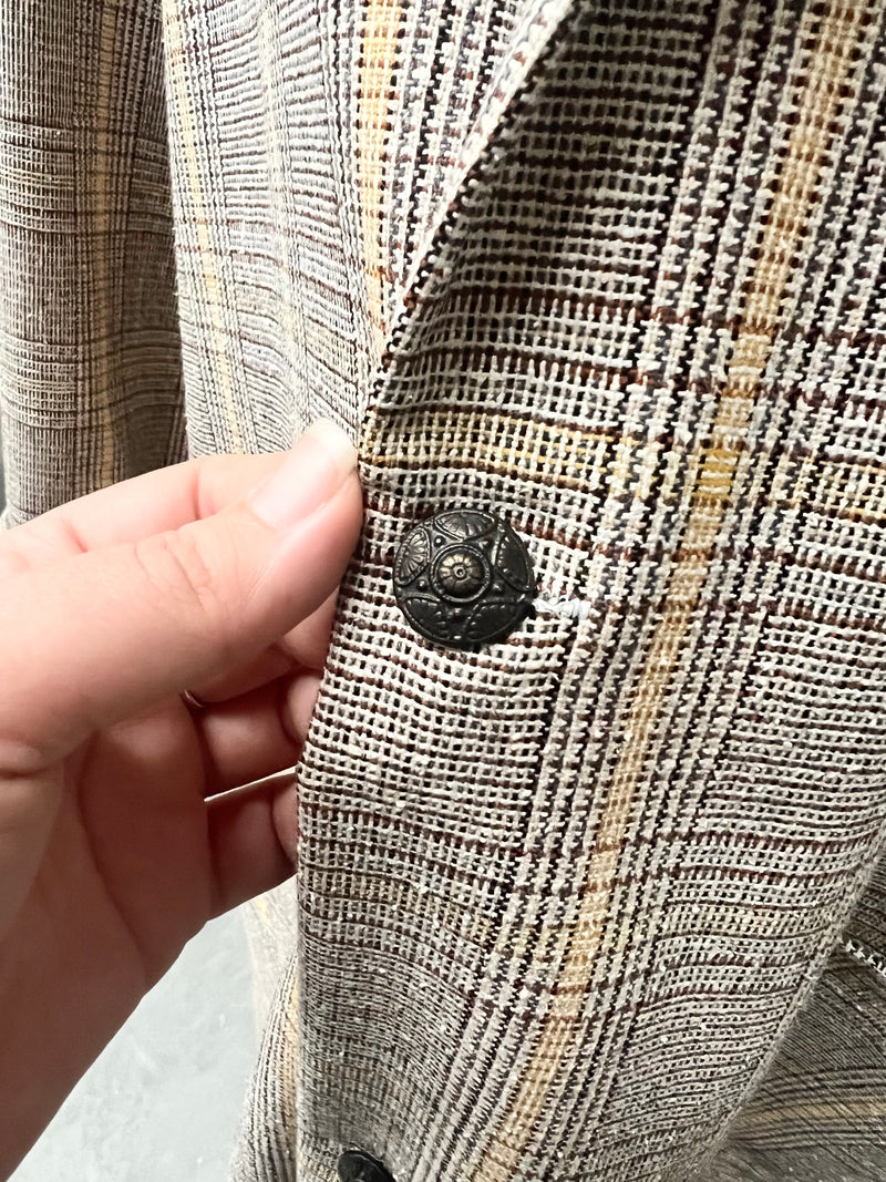 Close-up of the antique button detail on the plaid Ashton Overcoat